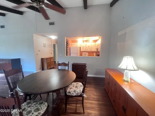 a dining room with furniture and window