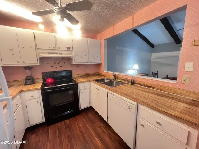 a kitchen with stainless steel appliances granite countertop a sink and cabinets
