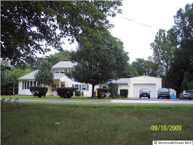 257 Harmony Road Middletown, NJ 07748 - Photo 1 of 3 a front view of a house with garden