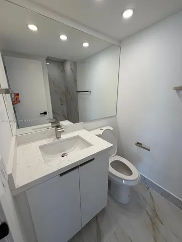 a bathroom with a sink a mirror and a sink