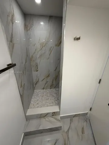a bathroom with a granite countertop toilet sink and shower