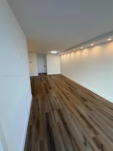 a view of wooden floor in an empty room