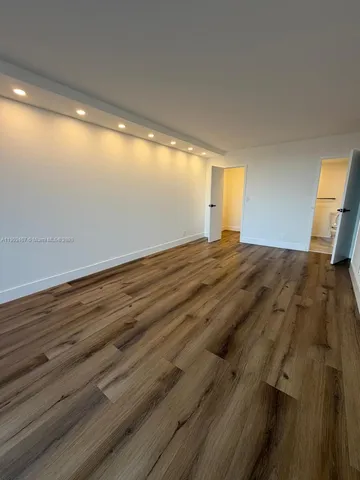 a view of room with wooden floor and window