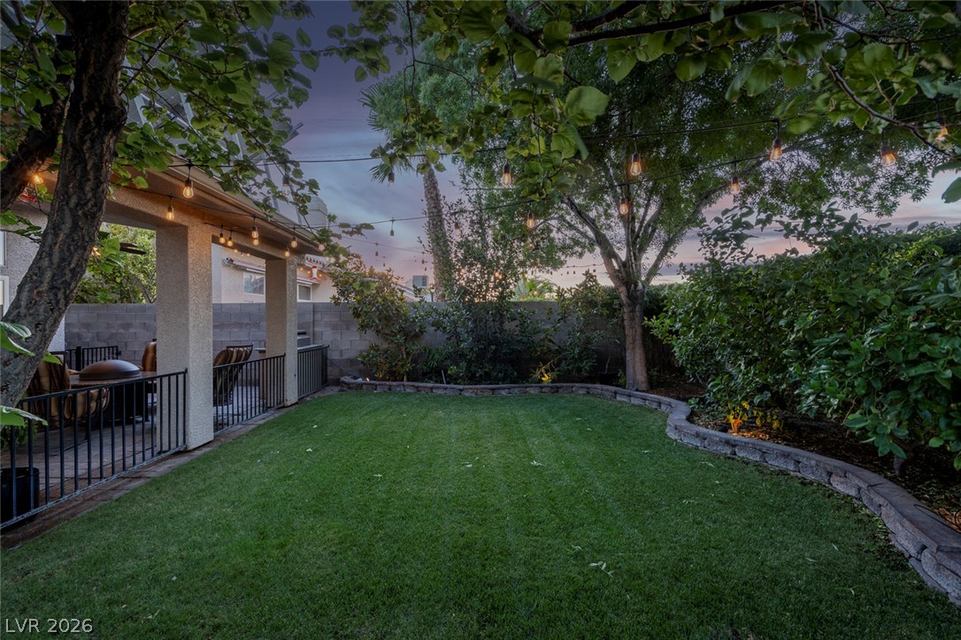 818 Manor Shores Road Henderson, NV 89002 - Photo 33 of 35 A private yard with string lights creates an inviting ambiance for outdoor gatherings.
