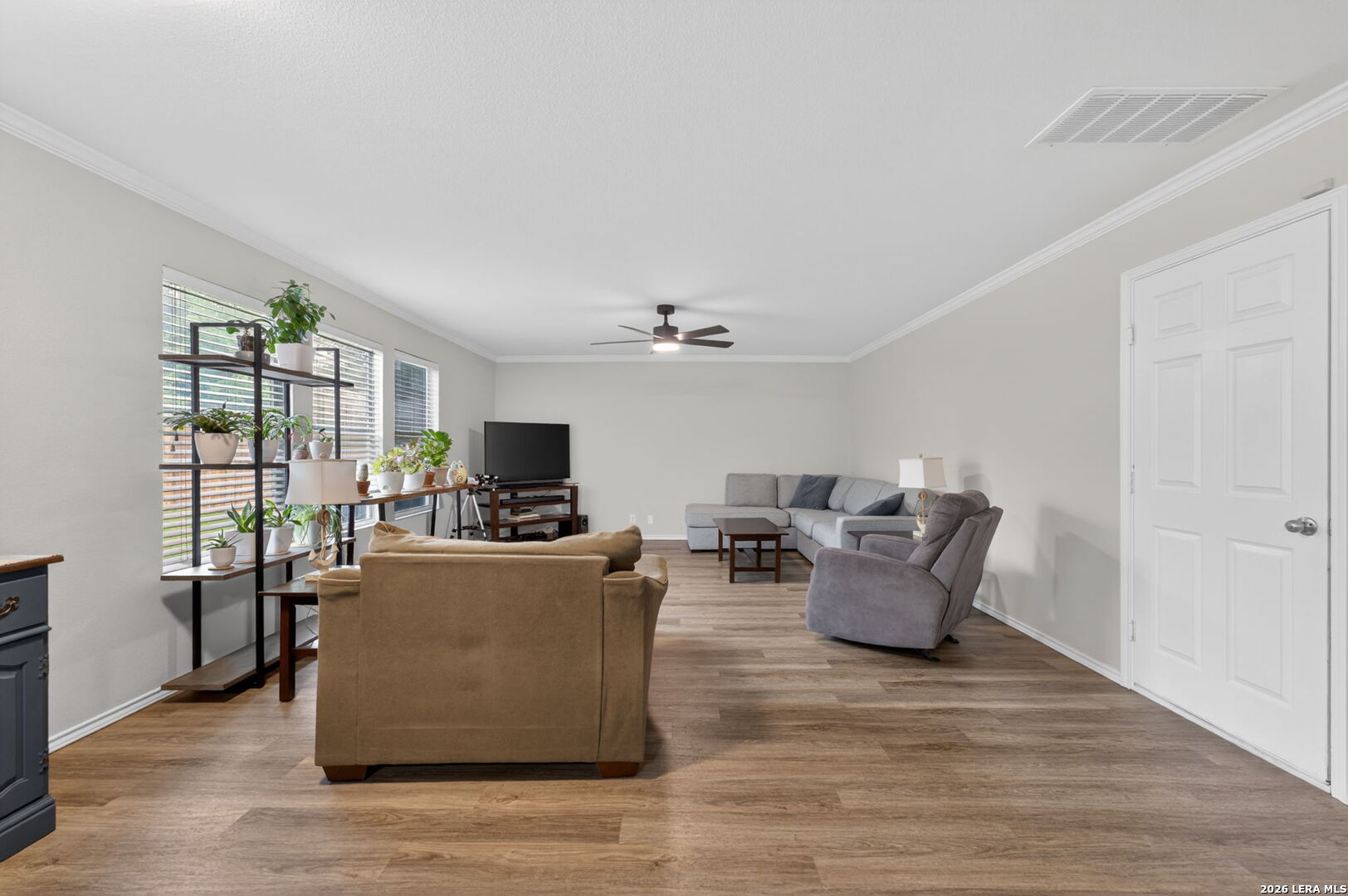 217 Willow Run Cibolo, TX 78108 - Photo 14 of 41 a living room with furniture a flat screen tv and a floor to ceiling window