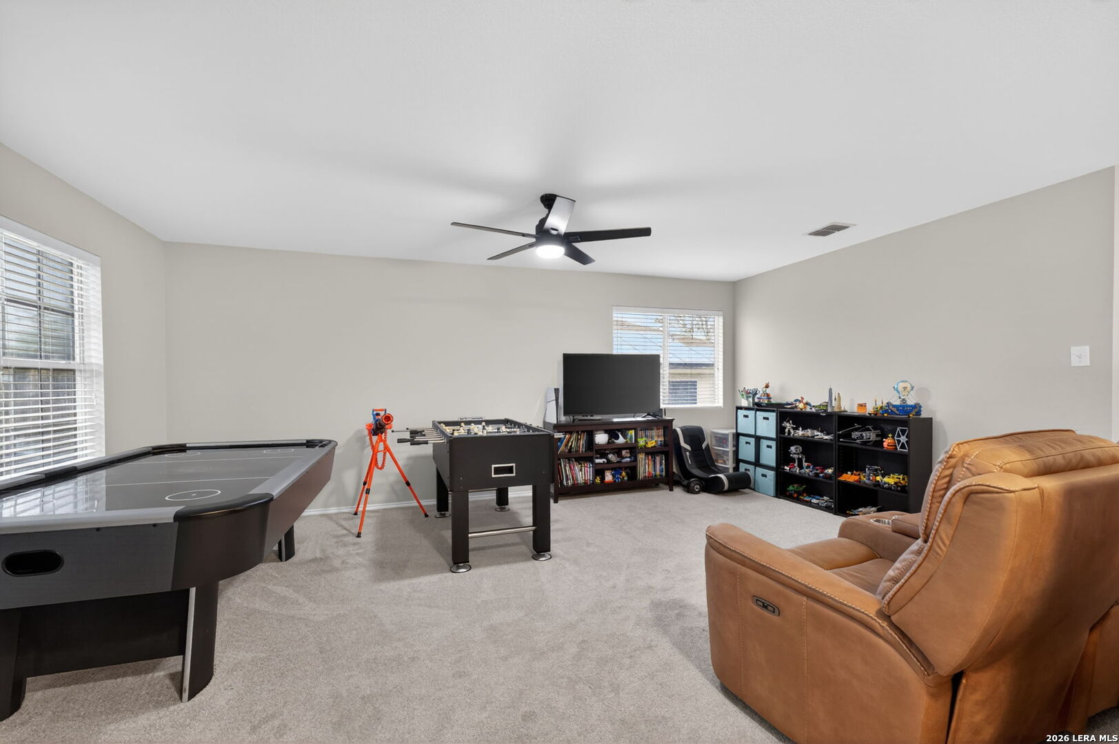 217 Willow Run Cibolo, TX 78108 - Photo 22 of 41 a living room with furniture and a flat screen tv with kitchen view