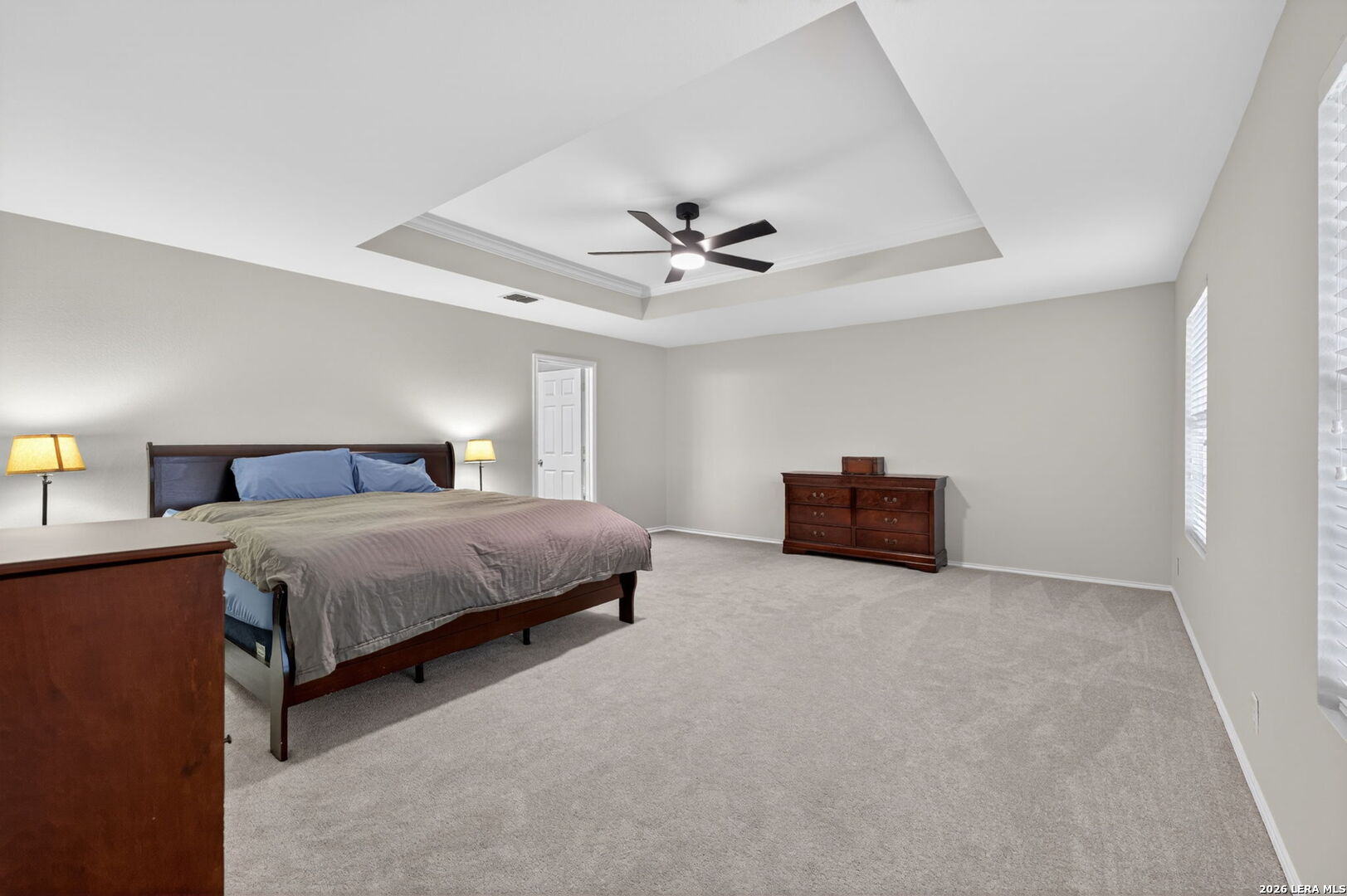 217 Willow Run Cibolo, TX 78108 - Photo 24 of 41 a spacious bedroom with a bed and a ceiling fan