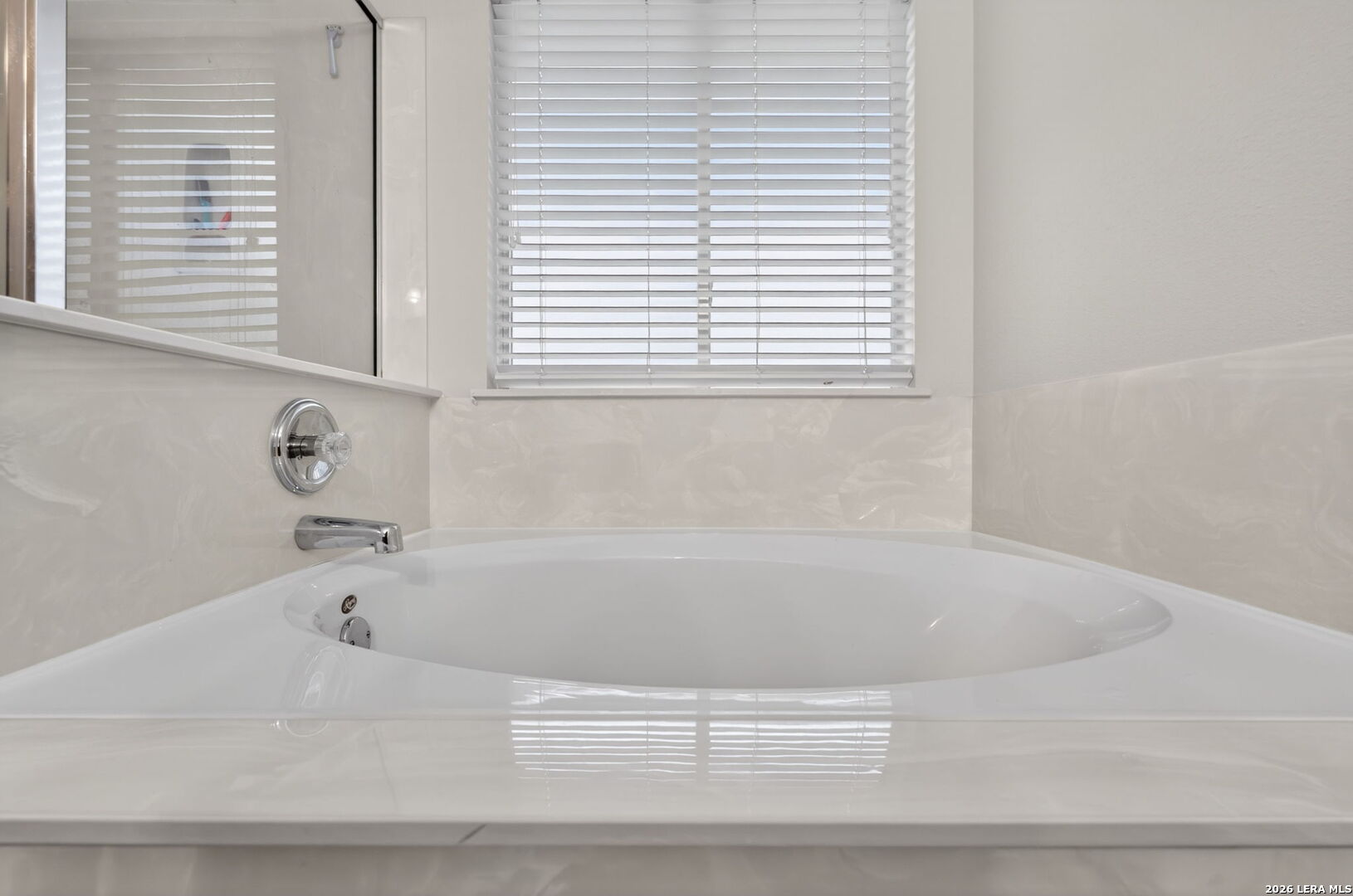 217 Willow Run Cibolo, TX 78108 - Photo 29 of 41 a white bath tub sitting in a bathroom next to a window
