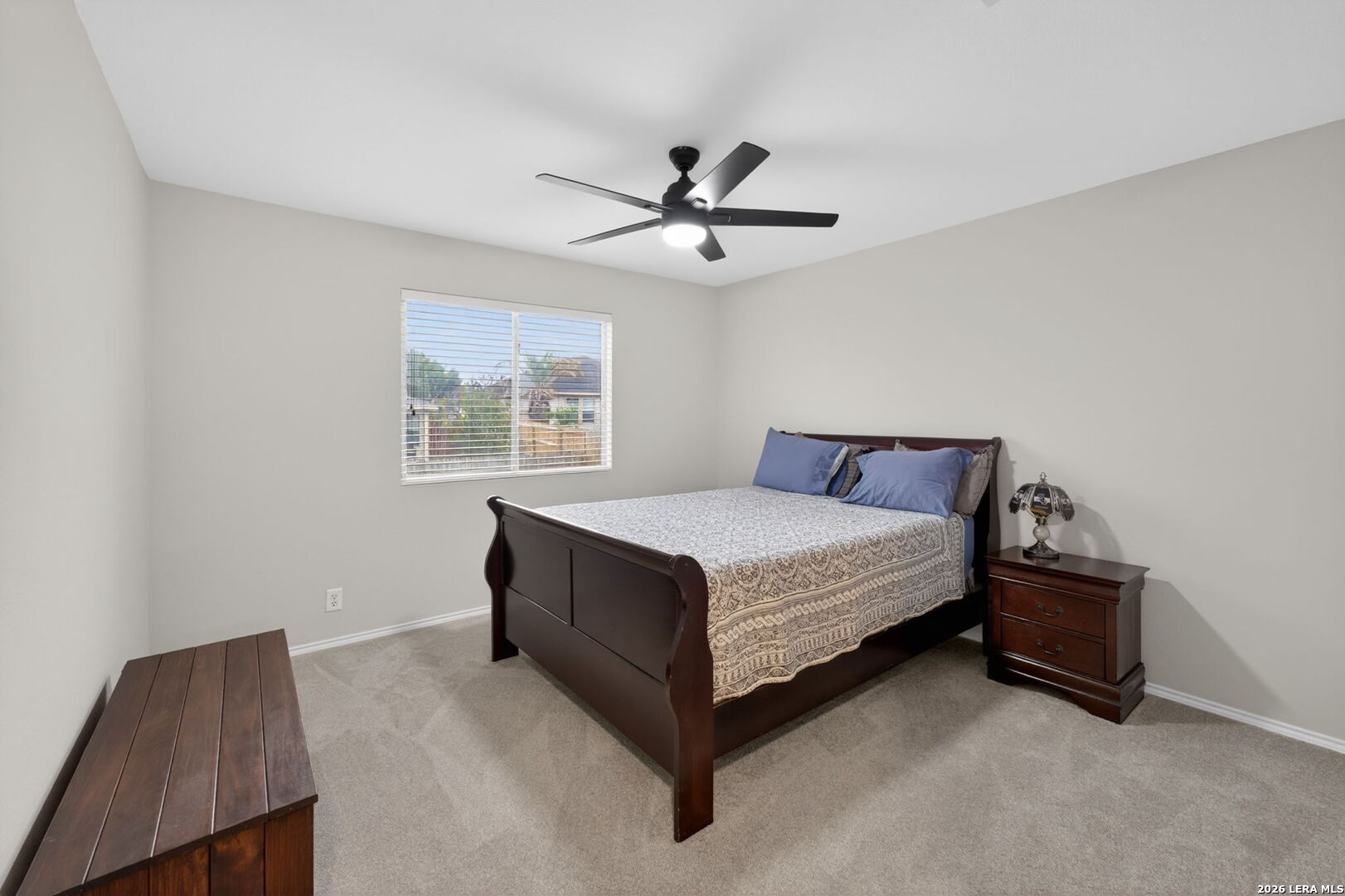 217 Willow Run Cibolo, TX 78108 - Photo 31 of 41 a bed sitting in a bedroom next to a window with a chandelier