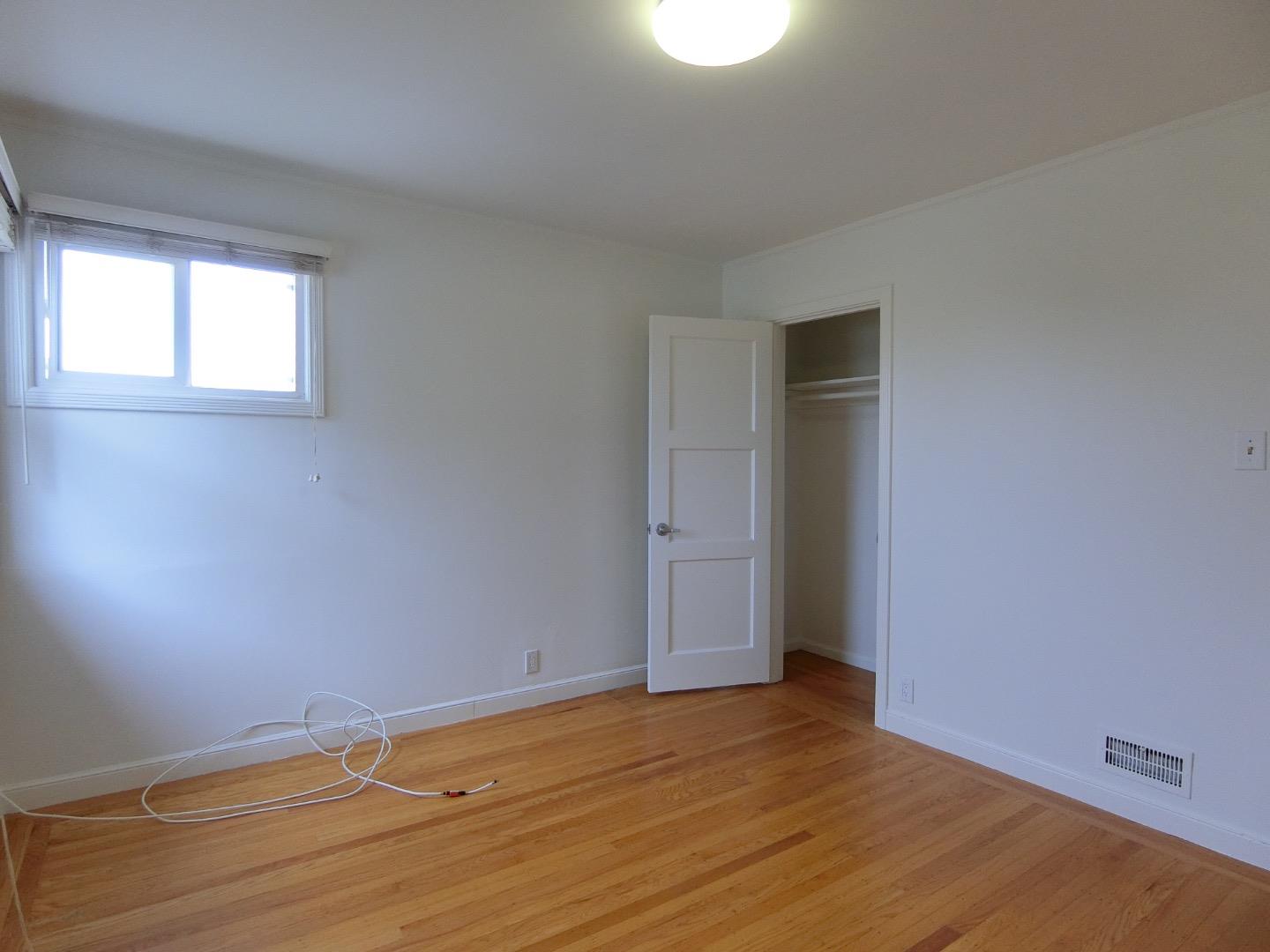 339 Paramount Drive Millbrae, CA 94030 - Photo 6 of 14 a view of an empty room with wooden floor and a window