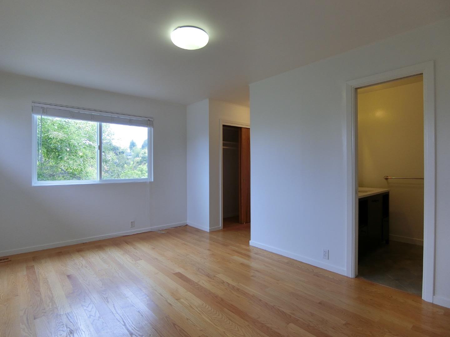 339 Paramount Drive Millbrae, CA 94030 - Photo 10 of 14 an empty room with wooden floor and windows