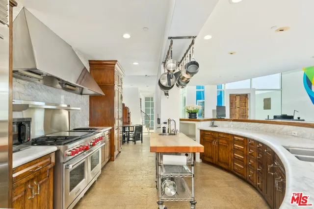 a large white kitchen with a large stove a sink and dishwasher