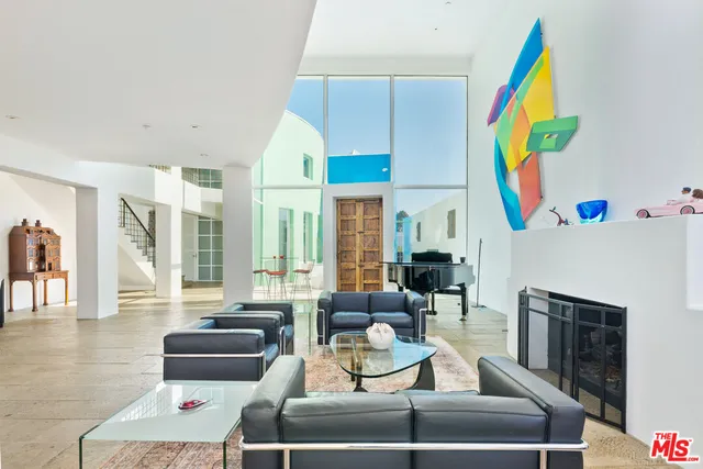 a living room with fireplace furniture and a fireplace