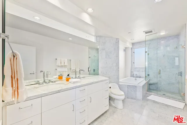 a bathroom with a double vanity sink toilet and shower