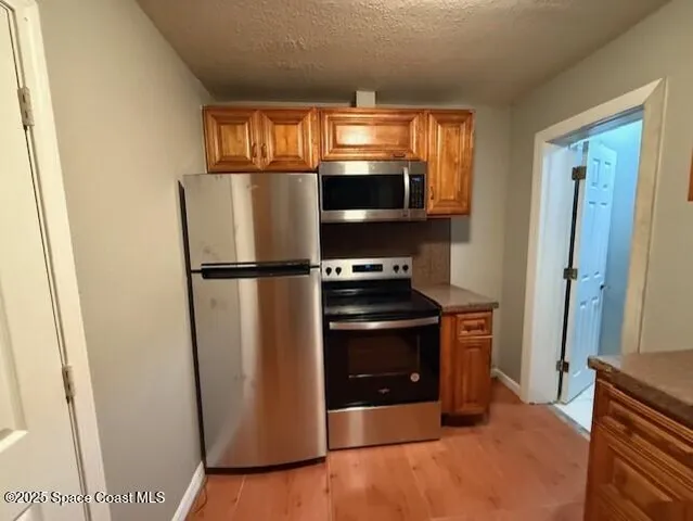 a kitchen with a stove microwave and refrigerator