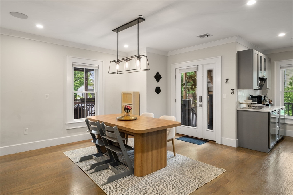 654 East 7th Street, Unit 3 Boston, MA 02127 - Photo 11 of 28 a living room with dining table and wooden floor