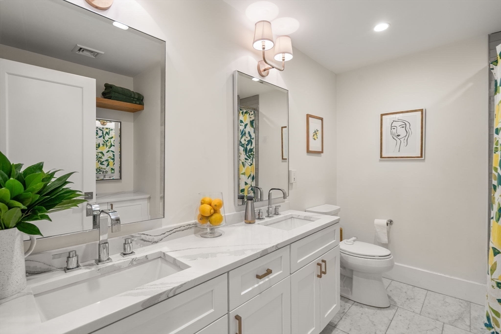 654 East 7th Street, Unit 3 Boston, MA 02127 - Photo 21 of 28 a bathroom with a sink a toilet and mirror