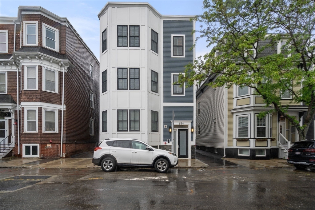 654 East 7th Street, Unit 3 Boston, MA 02127 - Photo 25 of 28 a car parked in front of a building