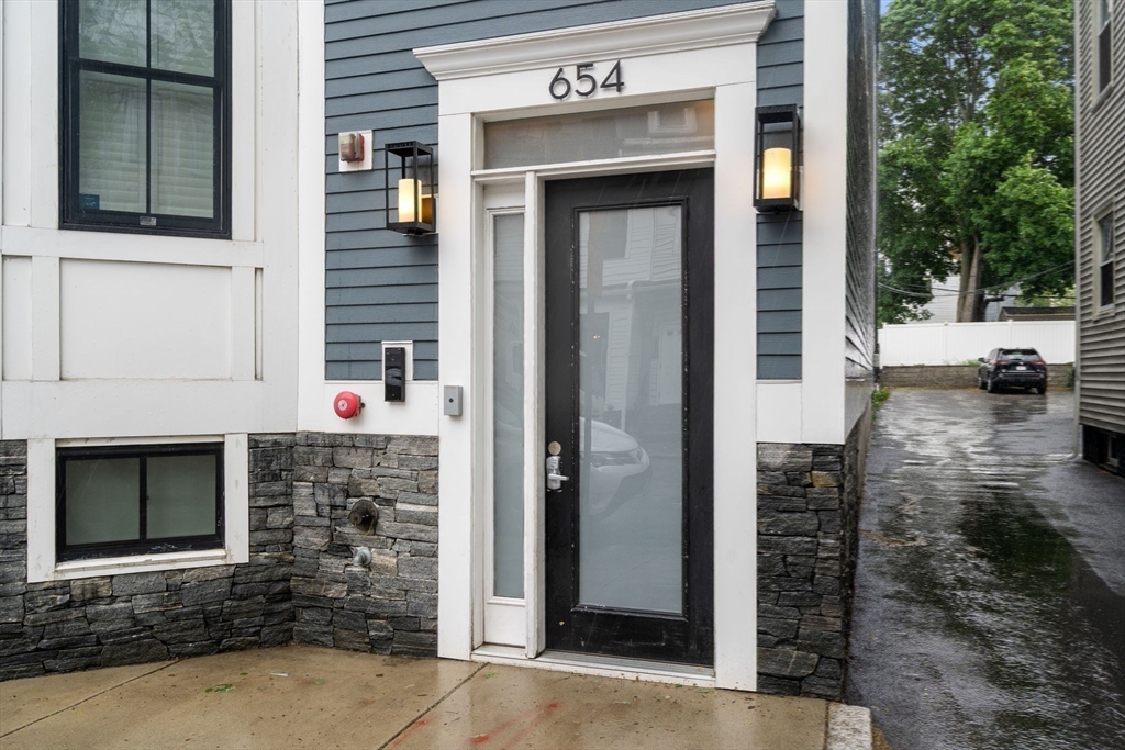 654 East 7th Street, Unit 3 Boston, MA 02127 - Photo 26 of 28 a front view of a house with a yard