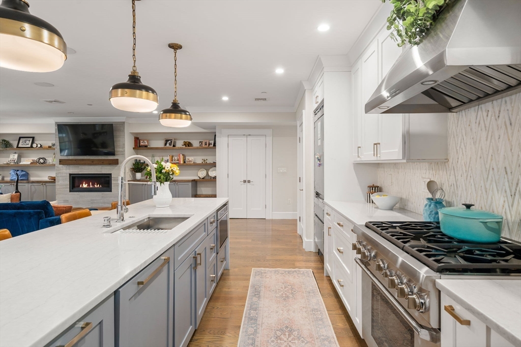 654 East 7th Street, Unit 3 Boston, MA 02127 - Photo 5 of 28 a kitchen with stainless steel appliances granite countertop a sink a stove and a wooden floors