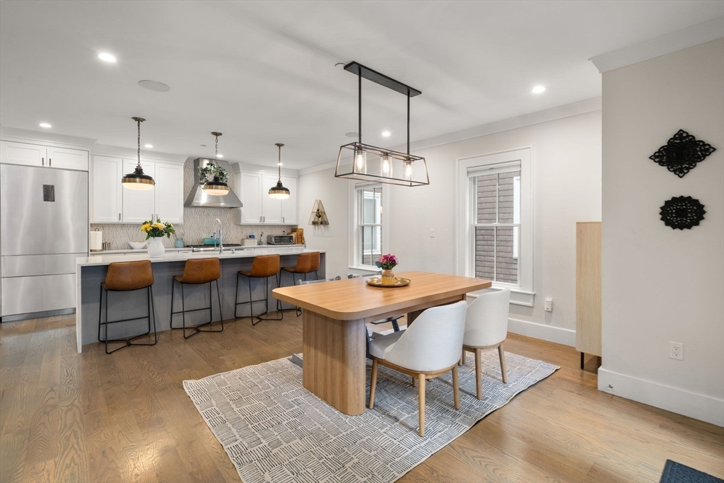 654 East 7th Street, Unit 3 Boston, MA 02127 - Photo 7 of 28 a room with stainless steel appliances kitchen island a table and chairs in it