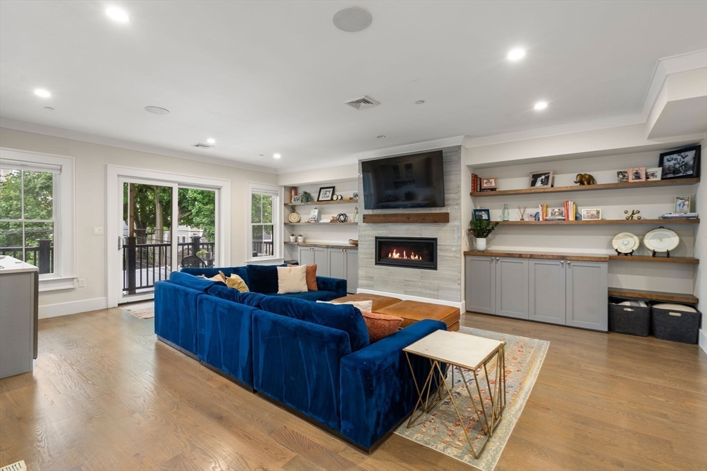 654 East 7th Street, Unit 3 Boston, MA 02127 - Photo 9 of 28 a living room with furniture a fireplace and a flat screen tv