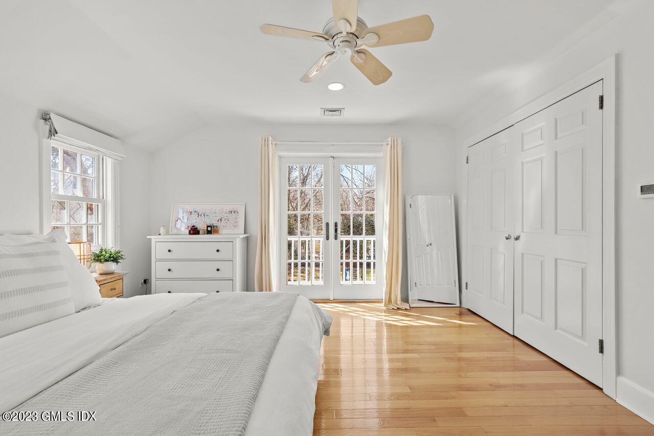 22 Linwood Avenue Riverside, CT 06878 - Photo 19 of 37 a spacious bedroom with a large bed and a chandelier fan