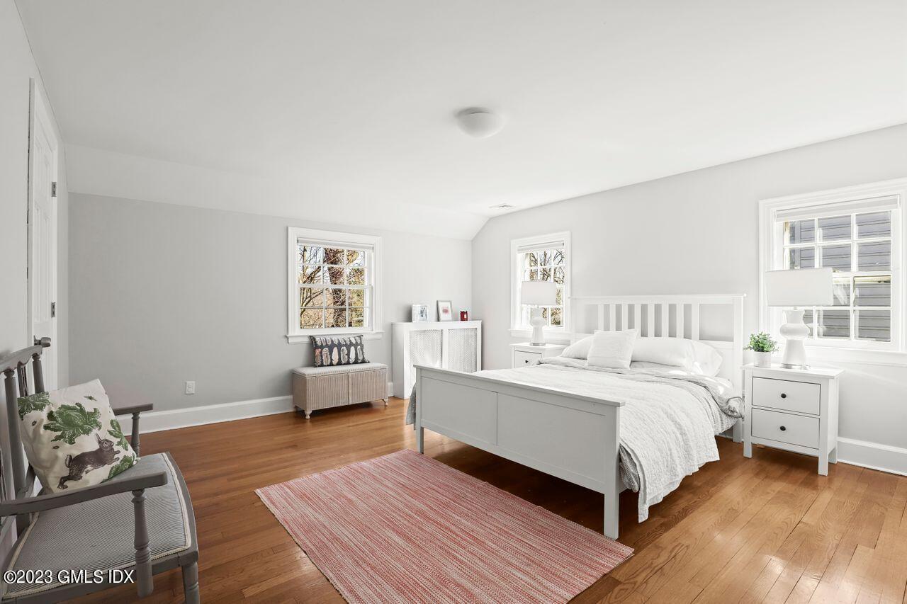 22 Linwood Avenue Riverside, CT 06878 - Photo 22 of 37 a spacious bedroom with a bed and a couch