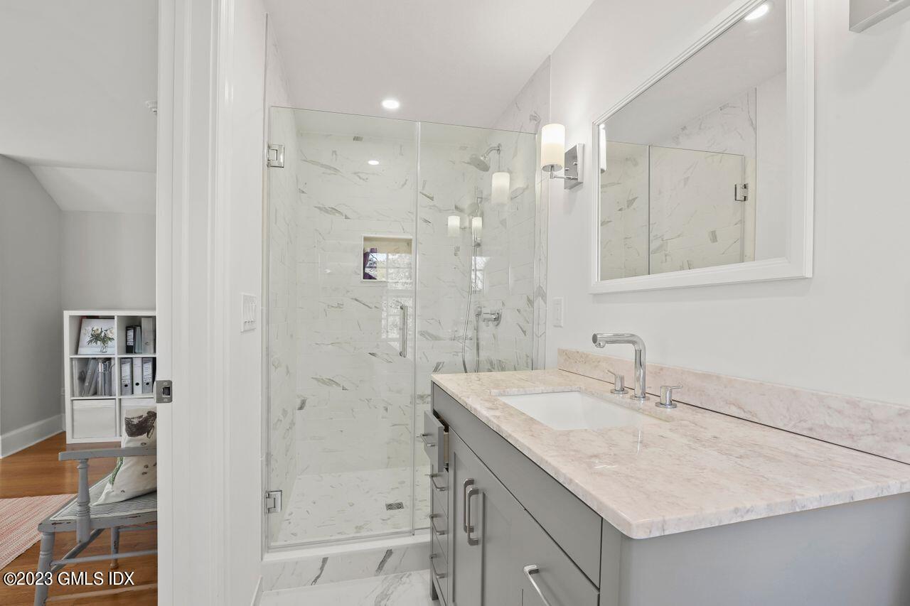22 Linwood Avenue Riverside, CT 06878 - Photo 23 of 37 a bathroom with a shower sink and mirror