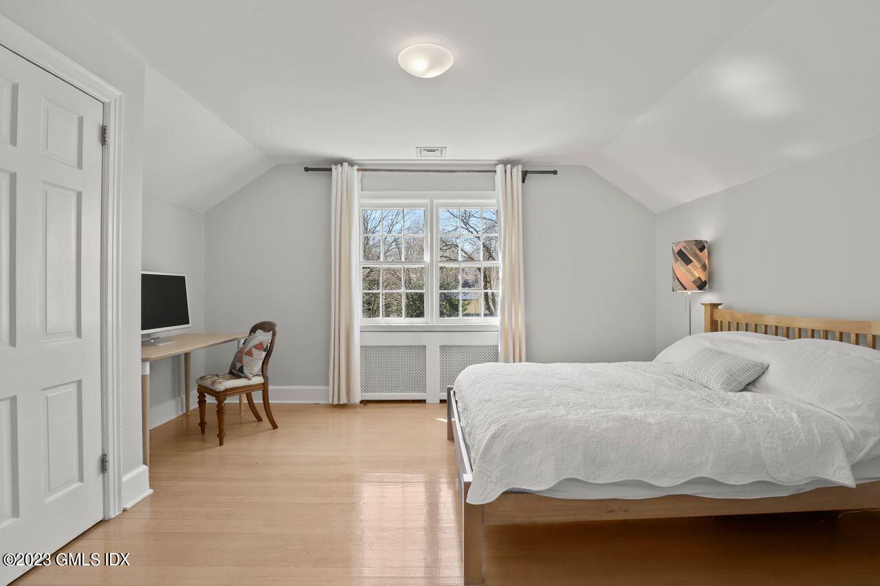22 Linwood Avenue Riverside, CT 06878 - Photo 25 of 37 a bedroom with a bed and a chair