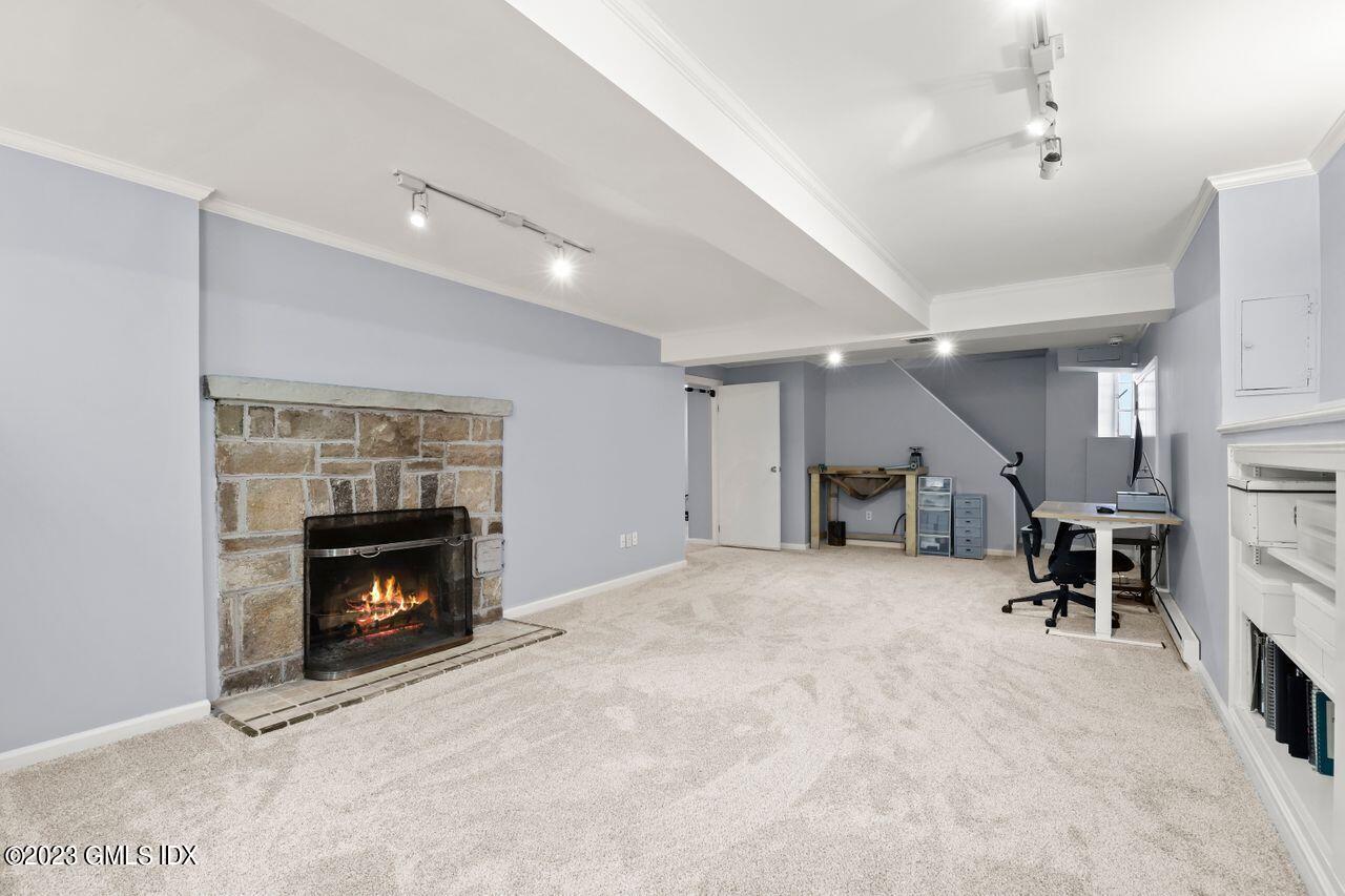22 Linwood Avenue Riverside, CT 06878 - Photo 28 of 37 a living room with furniture and a fireplace