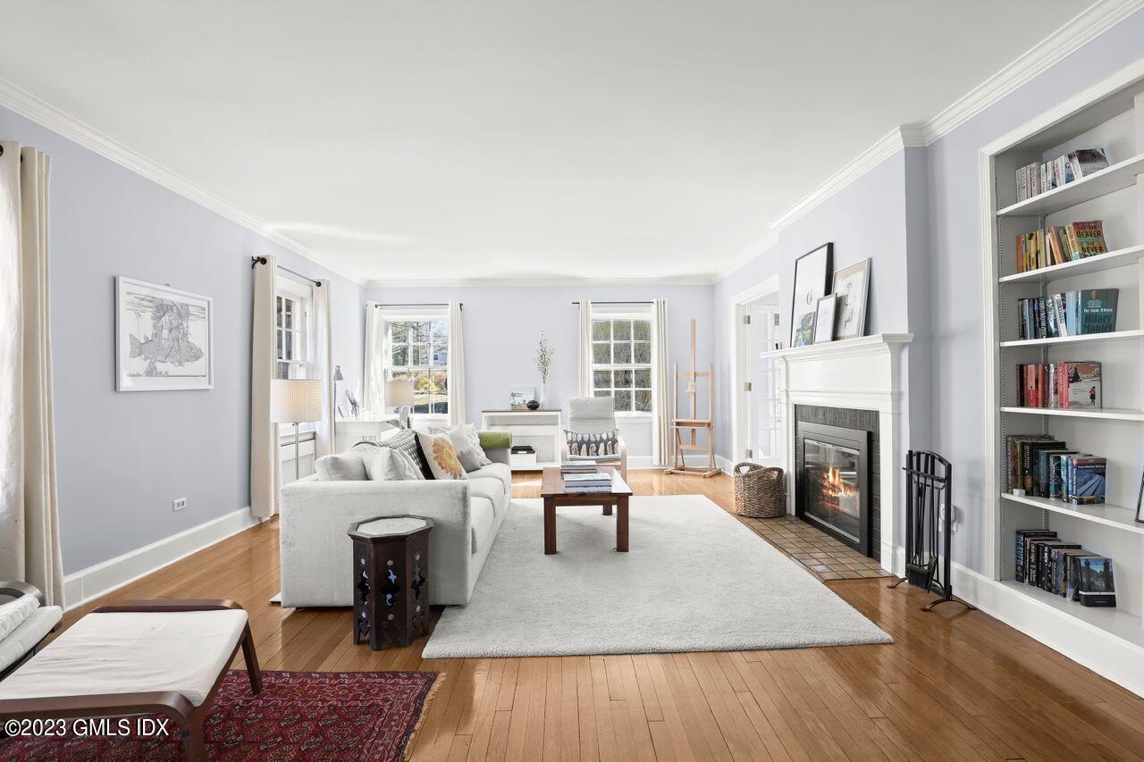 22 Linwood Avenue Riverside, CT 06878 - Photo 5 of 37 a living room with fireplace furniture and a book shelf