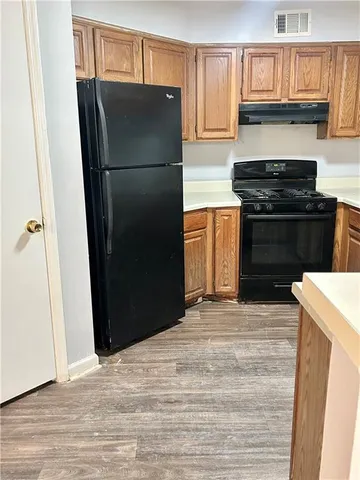 a kitchen with a refrigerator and a stove