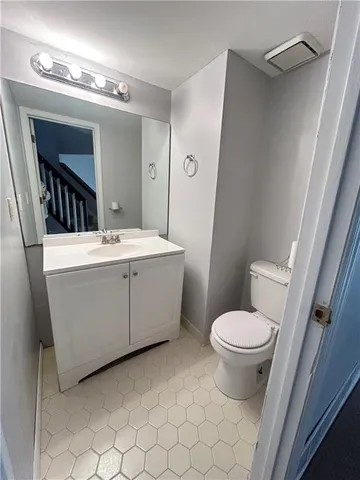 a bathroom with a sink toilet and mirror