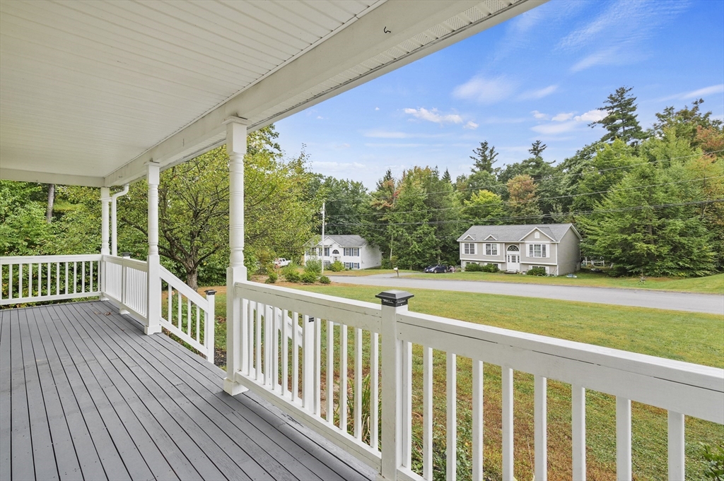 128 Green Farm Road New Ipswich, NH 03071 - Photo 2 of 39 a balcony with table and chairs