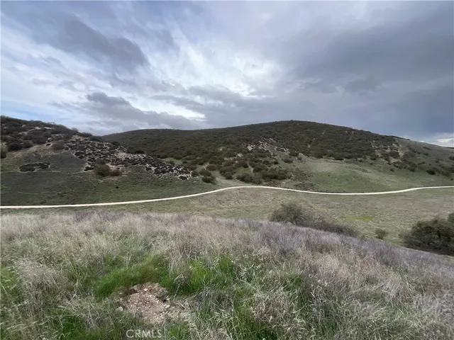 an aerial view of mountains and green space