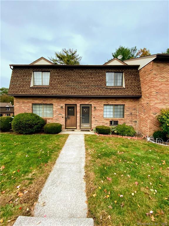 143 Pine Hill Road, Unit 22E Thomaston, CT 06787 - Photo 1 of 1 a front view of a house with a yard and garage