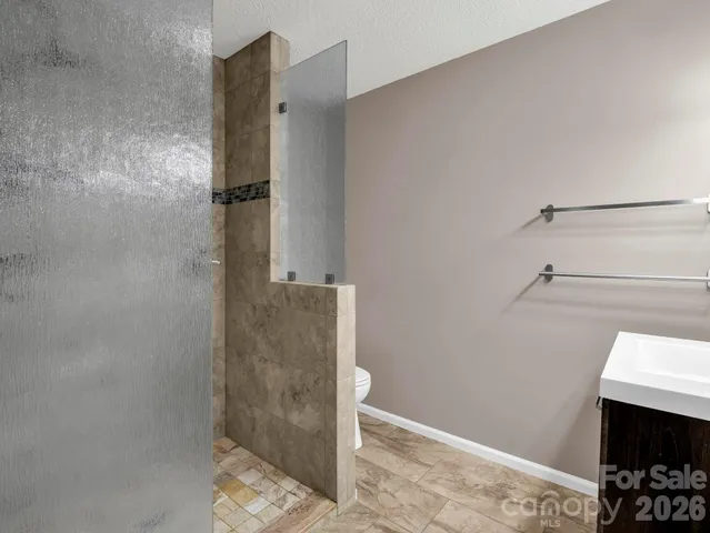 a bathroom with a shower and toilet