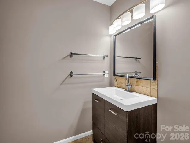 a bathroom with a sink vanity and a mirror