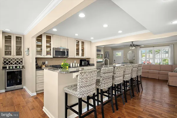 a living room with furniture a large window and a flat screen tv