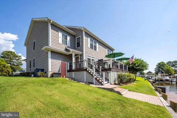 a view of a hallway with wooden floor and glass door