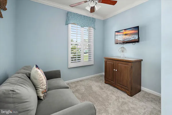 a bedroom with a bed and a flat tv screen on the dresser