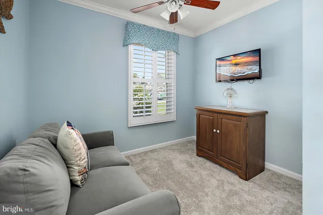 a bedroom with a bed and a flat tv screen on the dresser