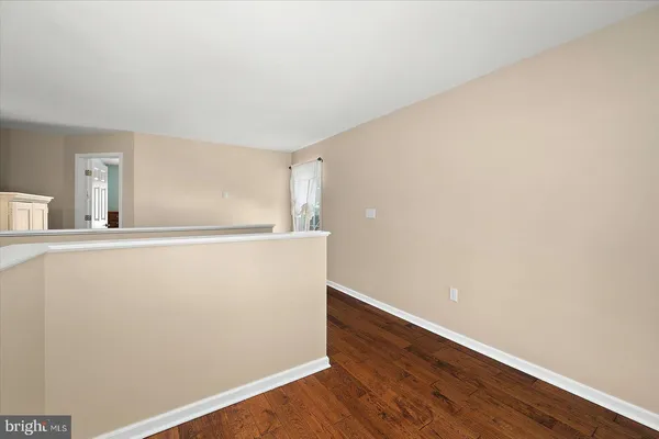a bedroom with a bed dresser and a window