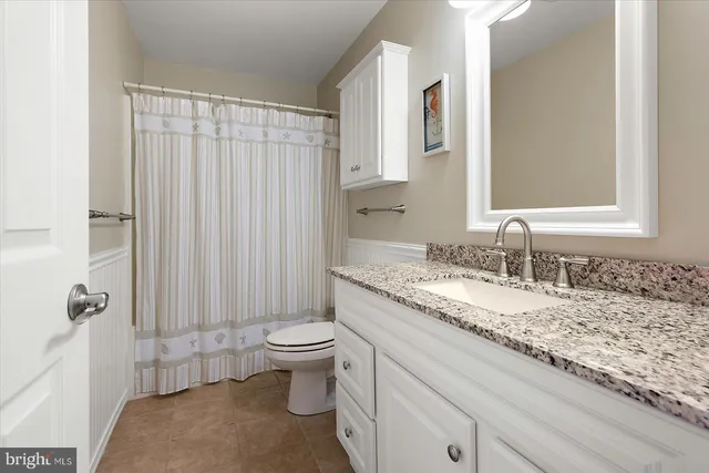 an aerial view of a house with outdoor space lake view and houses in the back