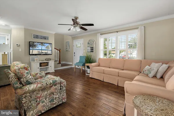 a kitchen with stainless steel appliances granite countertop a stove top oven a sink a dining table and chairs