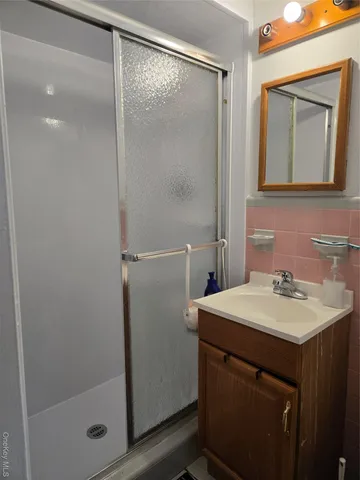 a bathroom with a sink vanity and mirror