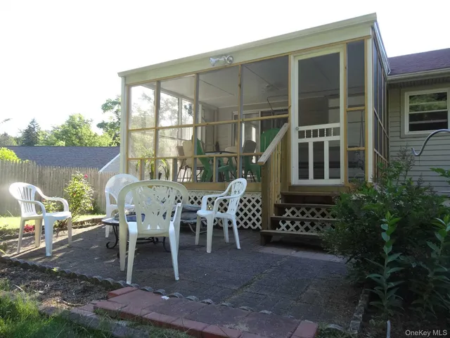 a view of a patio with table and chairs and potted plants