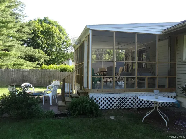 a table and chairs sitting in front of a house