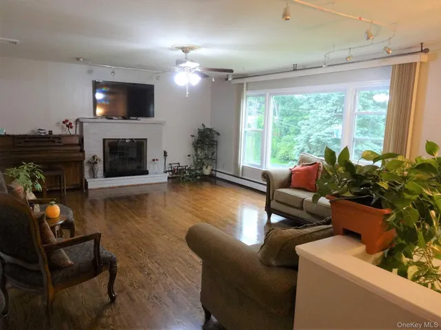 a living room with furniture a fireplace and a flat screen tv